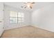 Simple bedroom with a ceiling fan, window and neutral carpeting at 2139 Briar Glen Sw Ln, Atlanta, GA 30331