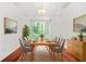 Light-filled dining room with a modern chandelier, table set for six, and elegant decor at 2139 Briar Glen Sw Ln, Atlanta, GA 30331