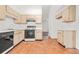 Well-lit kitchen with a stove, tile flooring, and wooden cabinets at 2139 Briar Glen Sw Ln, Atlanta, GA 30331