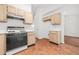 Bright kitchen with a stove, tile flooring, and wooden cabinets for a traditional feel at 2139 Briar Glen Sw Ln, Atlanta, GA 30331