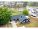Stunning aerial view of a blue home with a pond view and lush green yard at 2155 Old Dallas Rd, Marietta, GA 30064