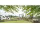 Green backyard with lush trees, pond, and a wooden fence enclosing the property at 2155 Old Dallas Rd, Marietta, GA 30064