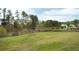 Expansive backyard with a lush green lawn, mature trees and access to a pond at 2155 Old Dallas Rd, Marietta, GA 30064