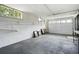 Unfinished basement with concrete floors, painted walls and large garage door at 2155 Old Dallas Rd, Marietta, GA 30064