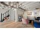 Spacious finished basement with exposed ceiling, wood floors and a cozy seating area at 2155 Old Dallas Rd, Marietta, GA 30064