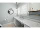 This bathroom boasts an open vanity, modern mirror and plantation shutters for lots of natural light at 2155 Old Dallas Rd, Marietta, GA 30064