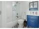 Stylish bathroom with a tub-shower combination, glass enclosure and a blue vanity at 2155 Old Dallas Rd, Marietta, GA 30064