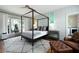 Charming bedroom with a four-poster bed, neutral color palette, and access to the laundry room at 2155 Old Dallas Rd, Marietta, GA 30064