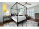 Comfortable bedroom with a four-poster bed, neutral colors, modern furnishings and hardwood floors at 2155 Old Dallas Rd, Marietta, GA 30064