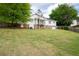 A view of the home from the backyard with a walkout basement and screened porch at 2155 Old Dallas Rd, Marietta, GA 30064