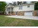Two-story home with a stone foundation, screened in back porch and an attached garage at 2155 Old Dallas Rd, Marietta, GA 30064