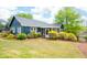 Charming blue house with well-manicured lawn, mature trees, and screened-in porch at 2155 Old Dallas Rd, Marietta, GA 30064