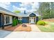 Inviting home with a manicured lawn, mature trees, and a classic brick walkway to the front door at 2155 Old Dallas Rd, Marietta, GA 30064