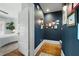 Well-lit hallway with art and hardwood floors leads into bedroom at 2155 Old Dallas Rd, Marietta, GA 30064