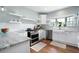 Bright kitchen with white cabinets, subway tile backsplash, stainless steel appliances, and open shelving at 2155 Old Dallas Rd, Marietta, GA 30064