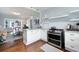 Bright kitchen features hardwood floors, white cabinets, stainless steel appliances, and flows into the living area at 2155 Old Dallas Rd, Marietta, GA 30064