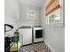 Convenient laundry room with side-by-side washer and dryer on a patterned tile floor at 2155 Old Dallas Rd, Marietta, GA 30064