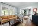 Cozy living room with a leather sofa, area rug, and view to the dining room at 2155 Old Dallas Rd, Marietta, GA 30064