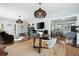 Open-concept living room and dining area with decorative lighting, a fireplace, and hardwood floors at 2155 Old Dallas Rd, Marietta, GA 30064