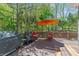Outdoor deck is furnished with grill, outdoor seating, and a large umbrella, perfect for entertaining at 335 Birkdale Dr, Fayetteville, GA 30215
