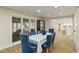 Dining area in finished basement featuring a table with blue chairs and natural light at 335 Birkdale Dr, Fayetteville, GA 30215