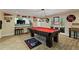 Finished basement area with a pool table, bar, and decorative sports memorabilia at 335 Birkdale Dr, Fayetteville, GA 30215