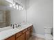 Modern bathroom featuring double sink vanity with light fixtures, and gray tile flooring and walk-in shower at 335 Birkdale Dr, Fayetteville, GA 30215