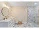Bathroom features marble countertops, sleek fixtures, and a stylish glass-enclosed shower for a spa-like experience at 335 Birkdale Dr, Fayetteville, GA 30215