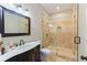Elegant bathroom with a marble countertop vanity and glass enclosed shower with tile surround at 335 Birkdale Dr, Fayetteville, GA 30215