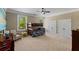 Large carpeted bedroom with bunkbeds, a reading chair, and two large windows offering natural light at 335 Birkdale Dr, Fayetteville, GA 30215