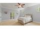 Serene bedroom with white walls, neutral carpet, decorative ceiling fan, and French doors leading to the second floor at 335 Birkdale Dr, Fayetteville, GA 30215