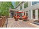 Relax on this spacious outdoor deck, featuring comfortable seating and an umbrella for shade at 335 Birkdale Dr, Fayetteville, GA 30215