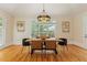 Bright dining room with a modern light fixture, large window, and seating for six at 335 Birkdale Dr, Fayetteville, GA 30215