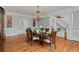 Formal dining room featuring a decorative chandelier, hardwood floors, and views of the staircase and entry at 335 Birkdale Dr, Fayetteville, GA 30215