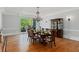 Bright dining room with hardwood floors, a chandelier, and large windows overlooking the landscape at 335 Birkdale Dr, Fayetteville, GA 30215