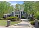 View of beautiful home with manicured landscaping and a circular driveway on a sunny day at 335 Birkdale Dr, Fayetteville, GA 30215