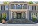 Grand home entrance with stone steps, white columns, decorative windows, and double doors at 335 Birkdale Dr, Fayetteville, GA 30215