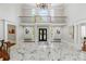 Bright, open foyer with marble floors, a grand staircase, and a beautiful chandelier at 335 Birkdale Dr, Fayetteville, GA 30215