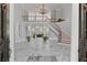 Grand two-story foyer with marble floors, a curved staircase, and views into the living room at 335 Birkdale Dr, Fayetteville, GA 30215