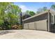 Exterior view of a three-car garage with a wide concrete driveway and well-maintained landscaping at 335 Birkdale Dr, Fayetteville, GA 30215