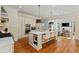 Modern kitchen with a large island, stainless steel appliances, and pendant lighting overlooking the living room at 335 Birkdale Dr, Fayetteville, GA 30215