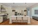 Gourmet kitchen with stainless steel appliances, custom cabinetry, large island, and stylish pendant lighting at 335 Birkdale Dr, Fayetteville, GA 30215
