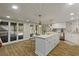 Bright eat-in kitchen with white cabinets, center island, stainless appliances, and access to the backyard at 335 Birkdale Dr, Fayetteville, GA 30215