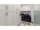 Well-organized laundry room features white cabinetry, marble floors, and new washer/dryer units at 335 Birkdale Dr, Fayetteville, GA 30215