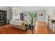 Open living room with large windows, a fireplace, and hardwood floors for a bright and inviting space at 335 Birkdale Dr, Fayetteville, GA 30215