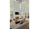 Bright living room with high ceilings, a stone fireplace, comfortable seating, and natural light at 335 Birkdale Dr, Fayetteville, GA 30215