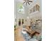 Bright living room boasts tall ceilings, hardwood floors, a comfortable sectional sofa, and a view into the kitchen at 335 Birkdale Dr, Fayetteville, GA 30215