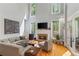 Cozy living room with a stone fireplace, large windows, comfortable seating, and hardwood floors at 335 Birkdale Dr, Fayetteville, GA 30215