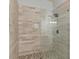 Walk-in shower featuring gray-toned tile surround, glass enclosure and pebble floor at 335 Birkdale Dr, Fayetteville, GA 30215