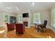 Sitting area with hardwood floors, a fireplace, tv, and sun-drenched skylights at 335 Birkdale Dr, Fayetteville, GA 30215